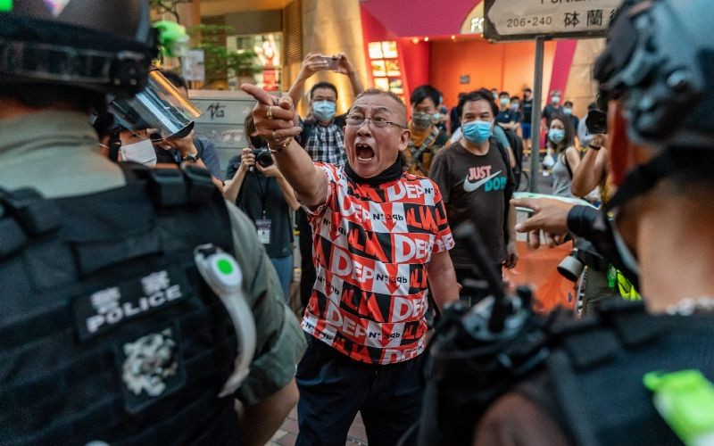 A pro-democracy supporter shouts at riot police during an anti-national security law rally in Mongkok district on June 12, 2020 in Hong Kong, China. (Photo by Anthony Kwan/Getty Images)